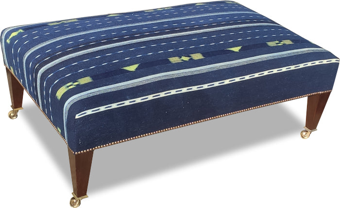 Low-leg magazine stool in blue fabric